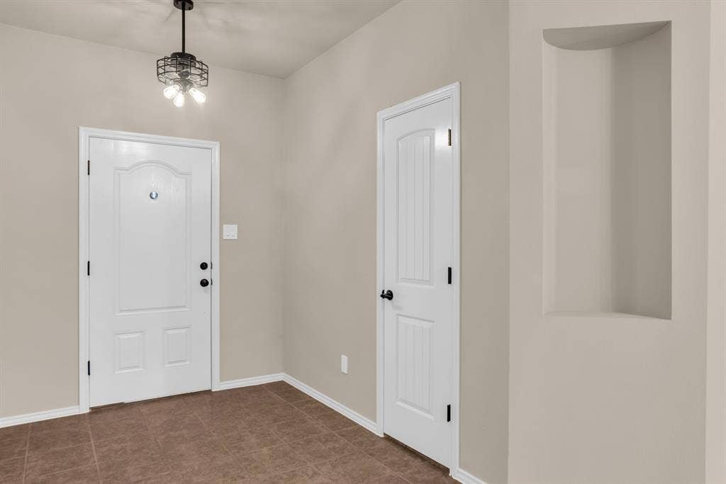 805 Andrews Court, Anna, TX 75409 Foyer area with fresh paint and light fixture.