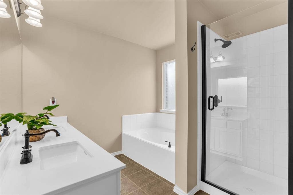 805 Andrews Court, Anna, TX 75409 Dual vanity with white countertops, undermount sinks, and dark bronze fixtures