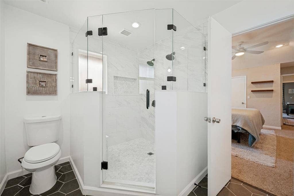 8420 Christie Drive, Frisco, TX 75033 Glass-enclosed shower with black hardware, white subway tile surround, and hexagonal floor tiles