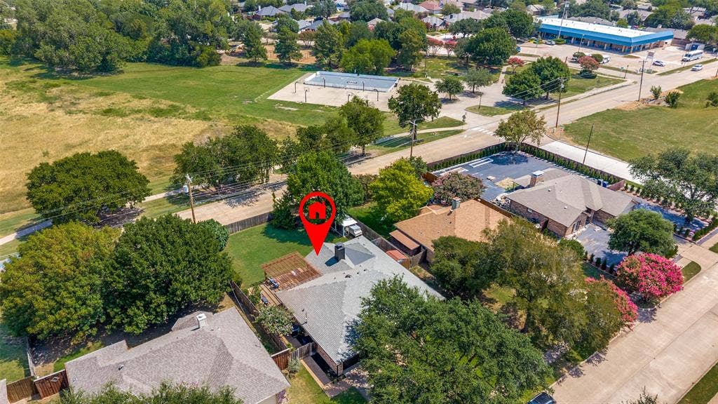8420 Christie Drive, Frisco, TX 75033 Aerial perspective highlighting a residential property with a gray impact rated shingle roof and mature surrounding trees