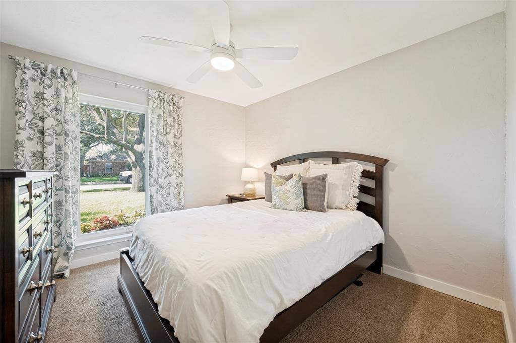 8420 Christie Drive, Frisco, TX 75033 2nd Bedroom with ceiling fan, light-colored walls, carpet flooring, and window with exterior landscaping views - makes for lovely Guest quarters.