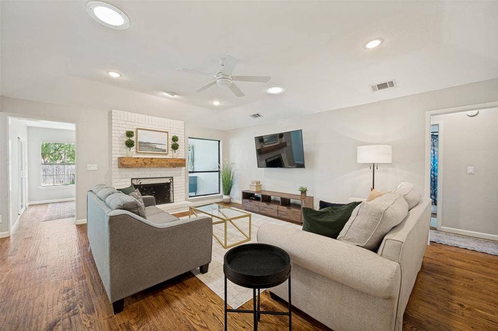 8420 Christie Drive, Frisco, TX 75033 Living area includes a white-painted brick fireplace with a wood mantel