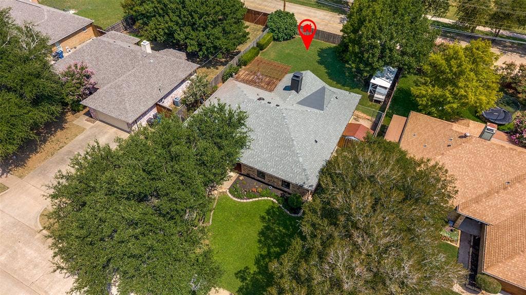 8420 Christie Drive, Frisco, TX 75033 View of new gray roof, established landscaping, a backyard shed, and a privacy fence