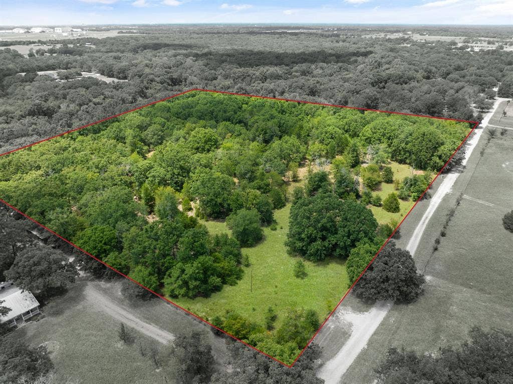 Expansive parcel featuring mature trees and open grassy areas