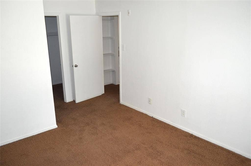 5500 Boca Raton Boulevard, #426, Fort Worth, TX 76112 Carpeted room with white walls, baseboards, and two doorways