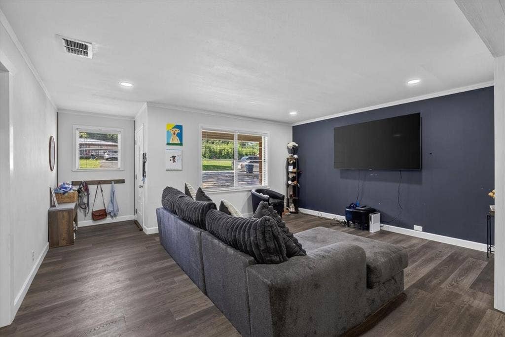 925 Maryland Drive, Athens, TX 75751 Spacious room featuring wood-finish flooring, recessed lighting, and a prominent accent wall