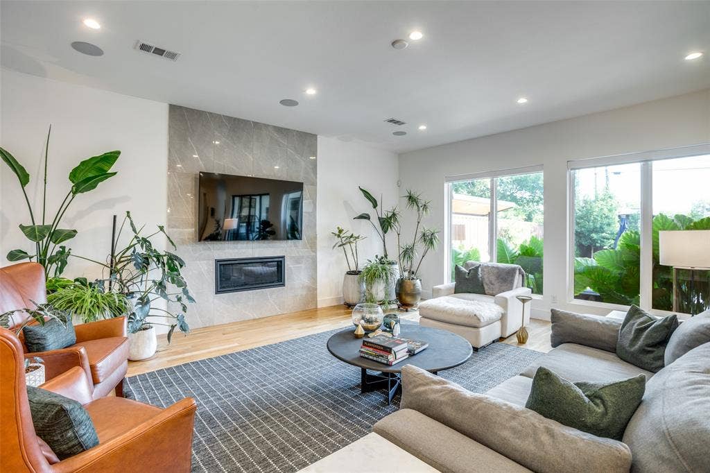 3766 Manana Drive, Dallas, TX 75220 Living room has auto ignite gas lighted stone fireplace. Large energy efficient low e3 double pane windows over looking the beautiful back yard. Electric blinds and full length sliding glass doors.