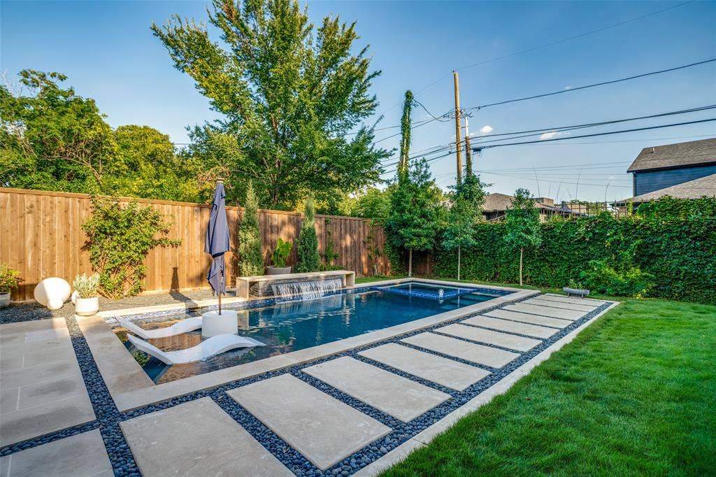 3766 Manana Drive, Dallas, TX 75220 The salt water pool contains an inviting spa and a tanning ledge. Gorgeous cement pavers are surrounded by river rock giving easy access to the pool.