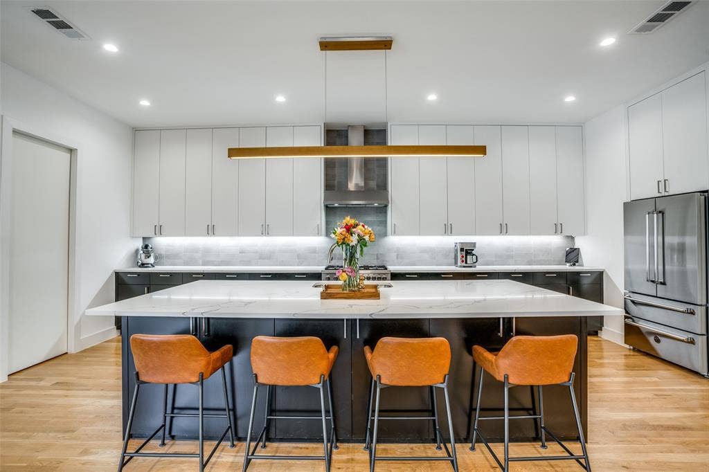 3766 Manana Drive, Dallas, TX 75220 Kitchen with large island and linear designer lighting.