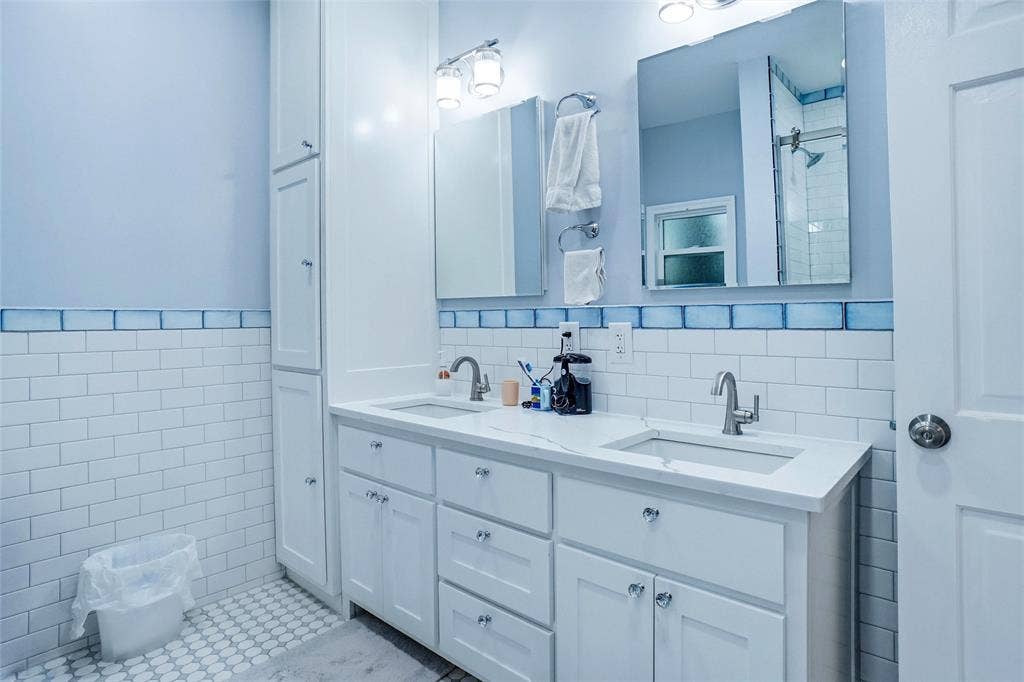 2306 Western Avenue, Fort Worth, TX 76107 Double vanity with white cabinetry and integrated sinks