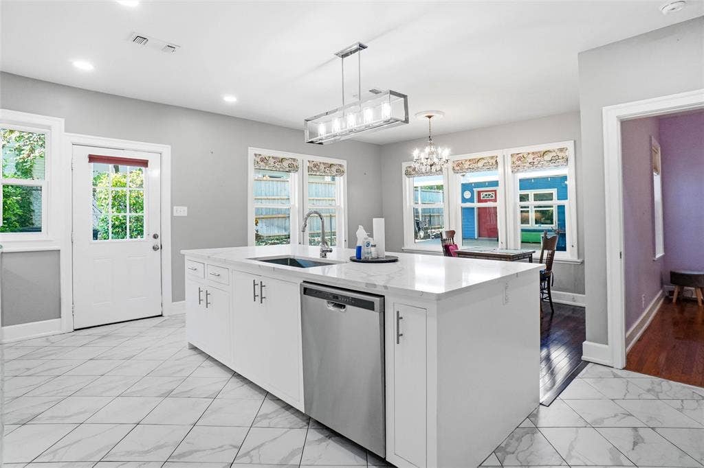 2306 Western Avenue, Fort Worth, TX 76107 Kitchen featuring a large central island with a built-in sink and stainless-steel dishwasher
