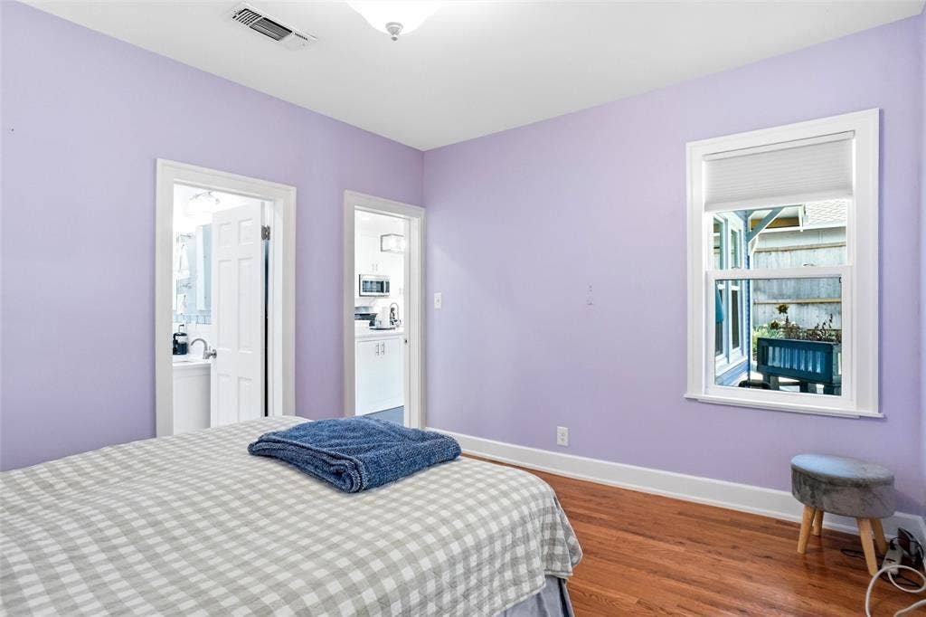2306 Western Avenue, Fort Worth, TX 76107 Room featuring a window with privacy blind, wood-finish flooring, and white baseboards