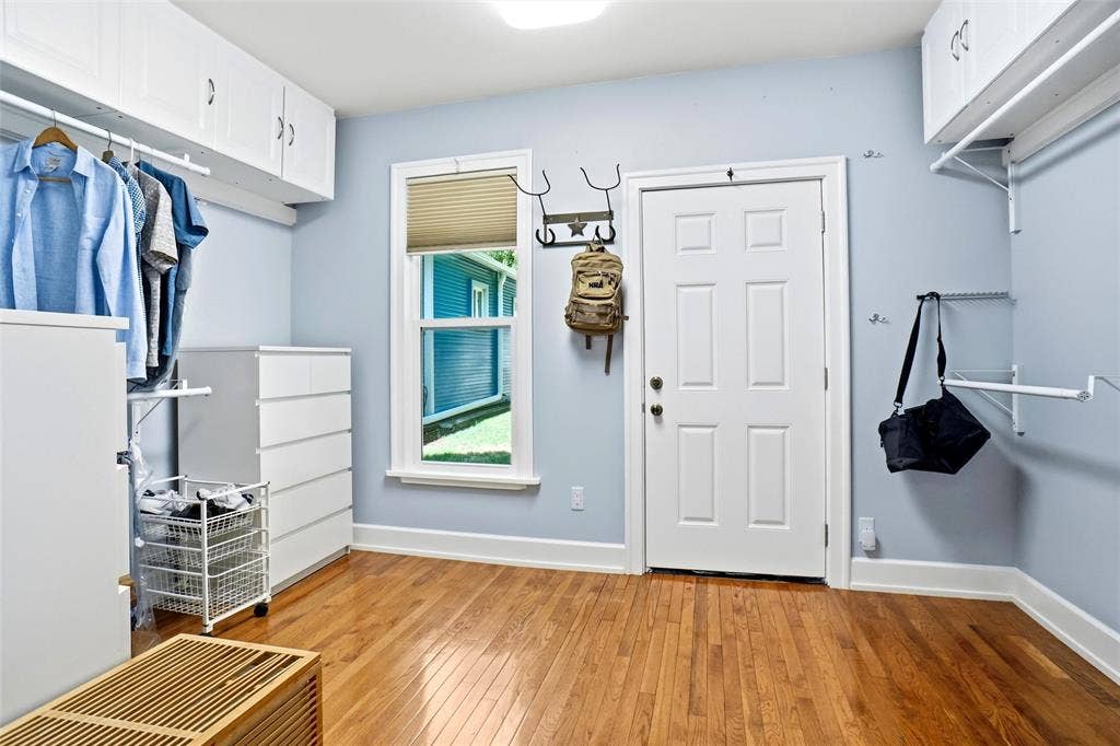 2306 Western Avenue, Fort Worth, TX 76107 Hardwood flooring throughout this versatile space featuring white baseboards, a paneled door, and a single window with blinds