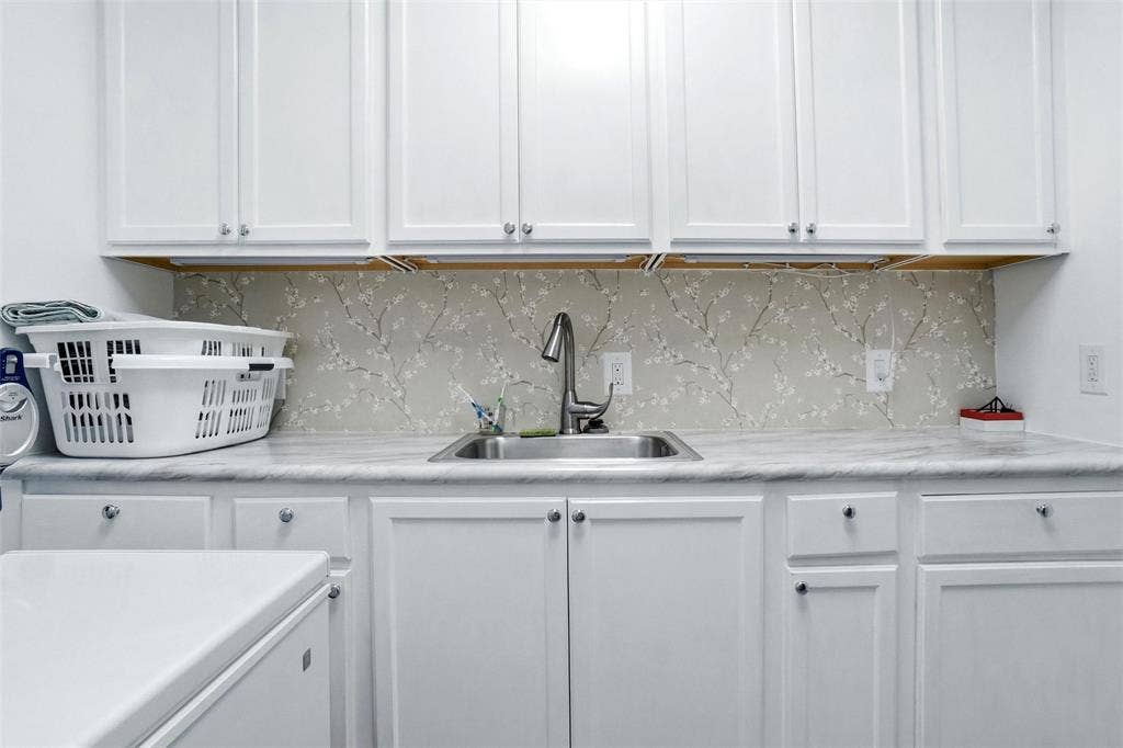 2306 Western Avenue, Fort Worth, TX 76107 White cabinetry featuring brushed nickel hardware