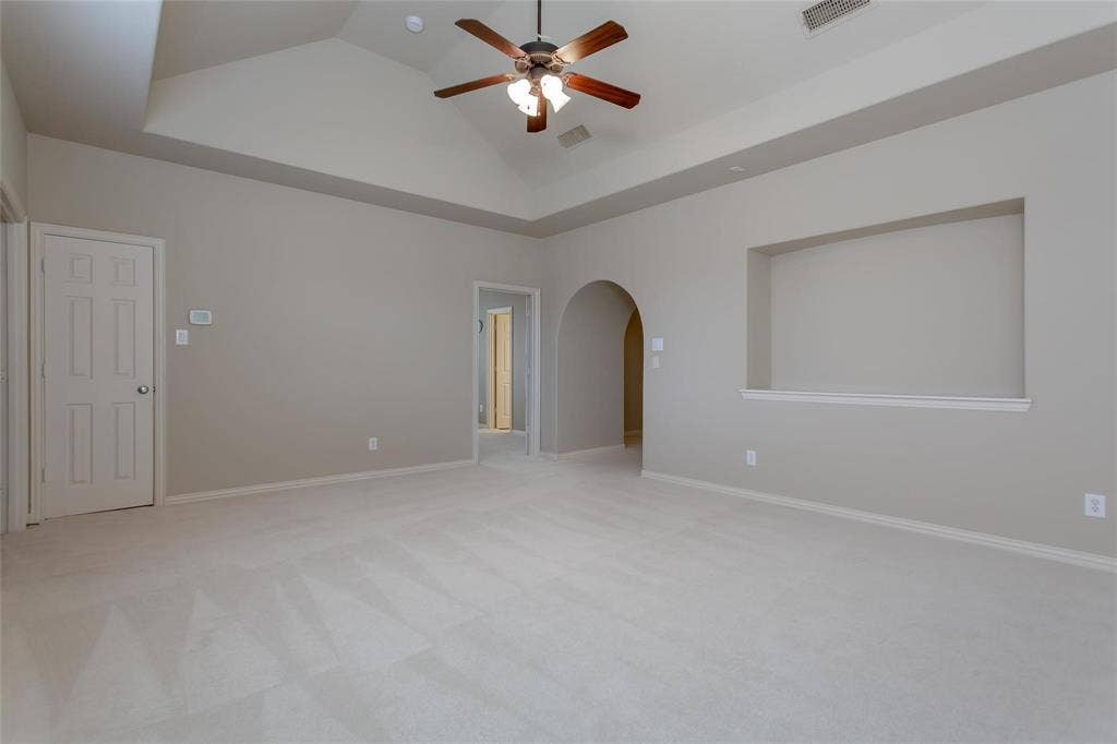 921 Pine Burst Drive, Allen, TX 75013 Spacious room featuring a vaulted ceiling with a ceiling fan, plush carpeting, and neutral wall tones