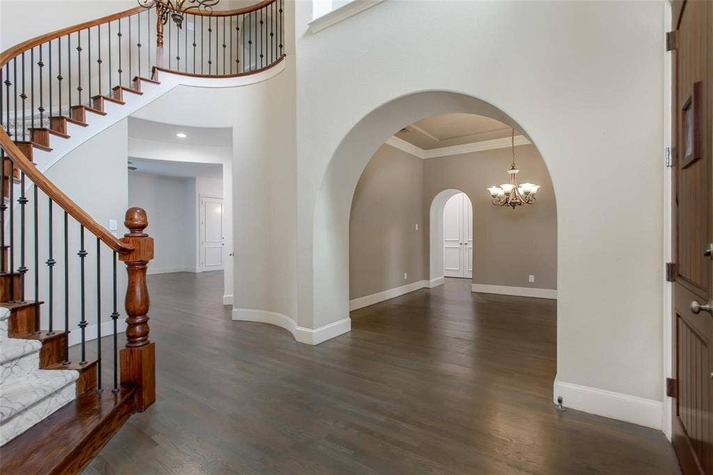 921 Pine Burst Drive, Allen, TX 75013 Grand entry foyer featuring a curved staircase with wood treads and wrought iron balusters