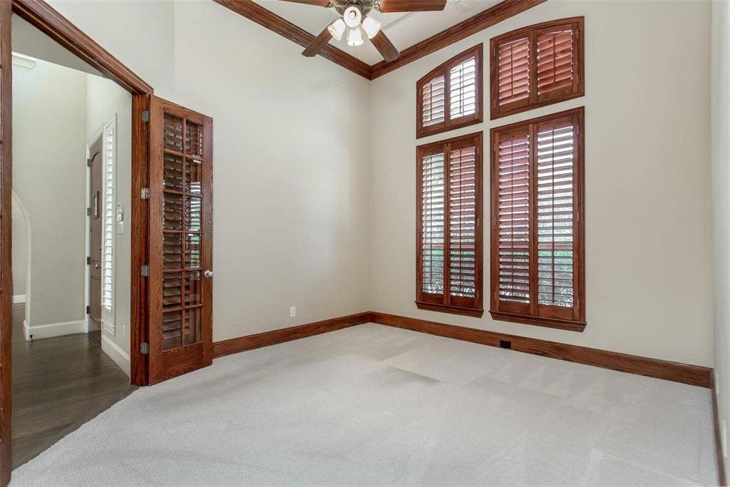 921 Pine Burst Drive, Allen, TX 75013 Interior space featuring vaulted ceilings, light-toned carpeting, and wood-finish trim