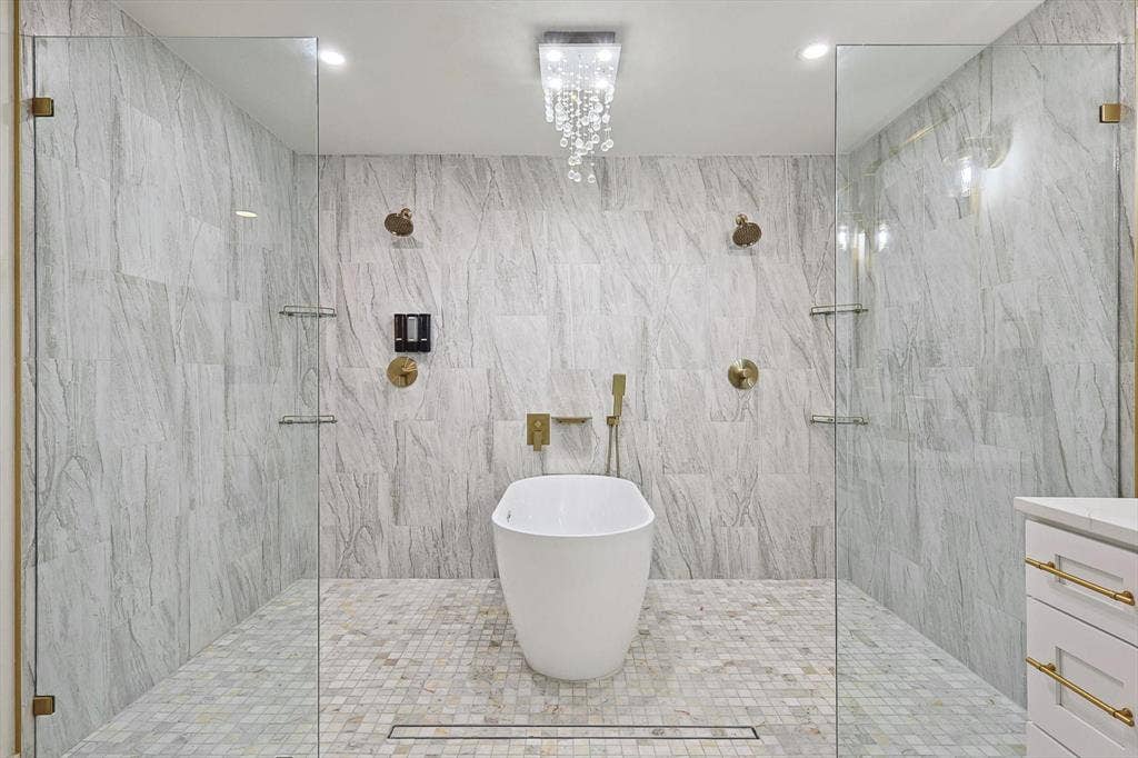 1208 Mayleaf Drive, Irving, TX 75060 Freestanding soaking tub centered within a spacious wet room featuring two glass-enclosed shower areas