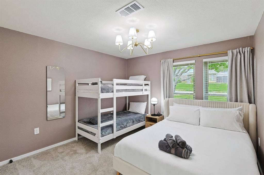 1208 Mayleaf Drive, Irving, TX 75060 Carpeted bedroom featuring a double bunk bed and a separate bed with a winged headboard