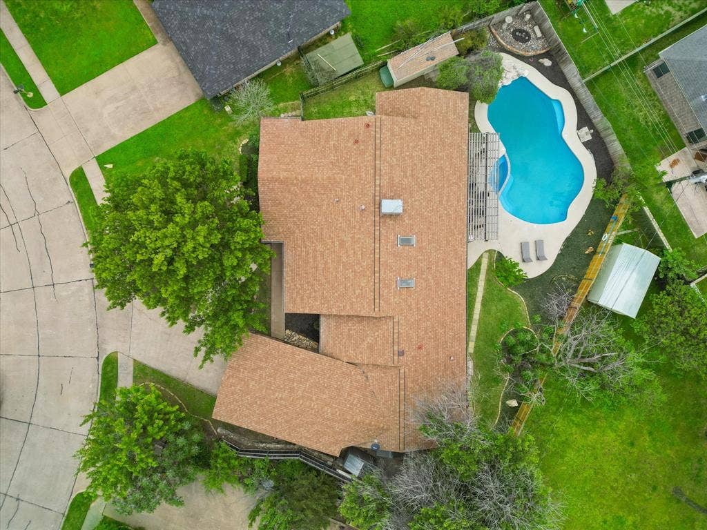 1208 Mayleaf Drive, Irving, TX 75060 Expansive backyard featuring a freeform swimming pool, concrete patio, and a pergola structure