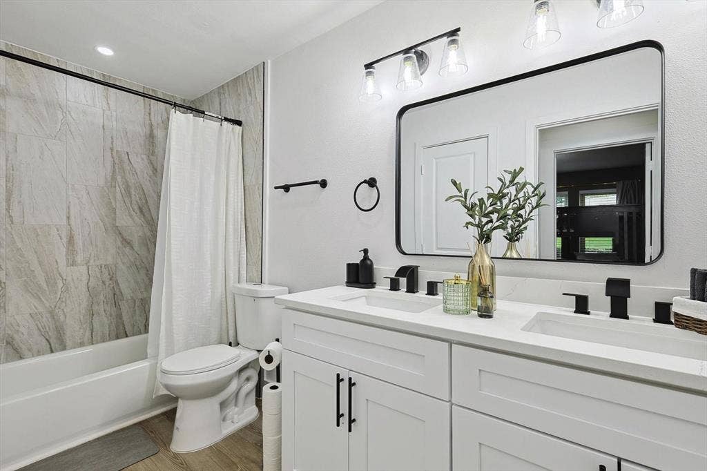 1208 Mayleaf Drive, Irving, TX 75060 Bathroom featuring a dual-sink vanity with white cabinetry and quartz countertops