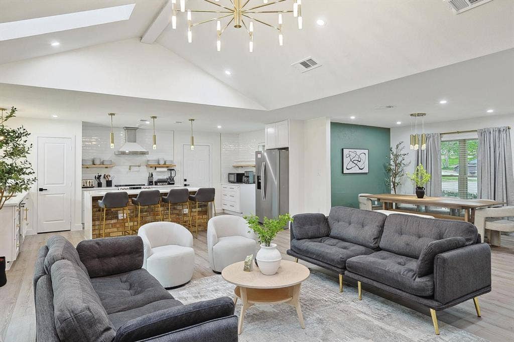 1208 Mayleaf Drive, Irving, TX 75060 Vaulted ceiling with an overhead skylight and contemporary chandelier