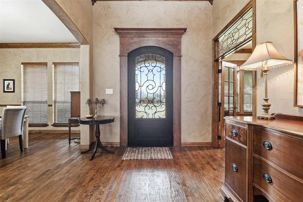 Arched entry door with decorative glass and wrought iron detailing
