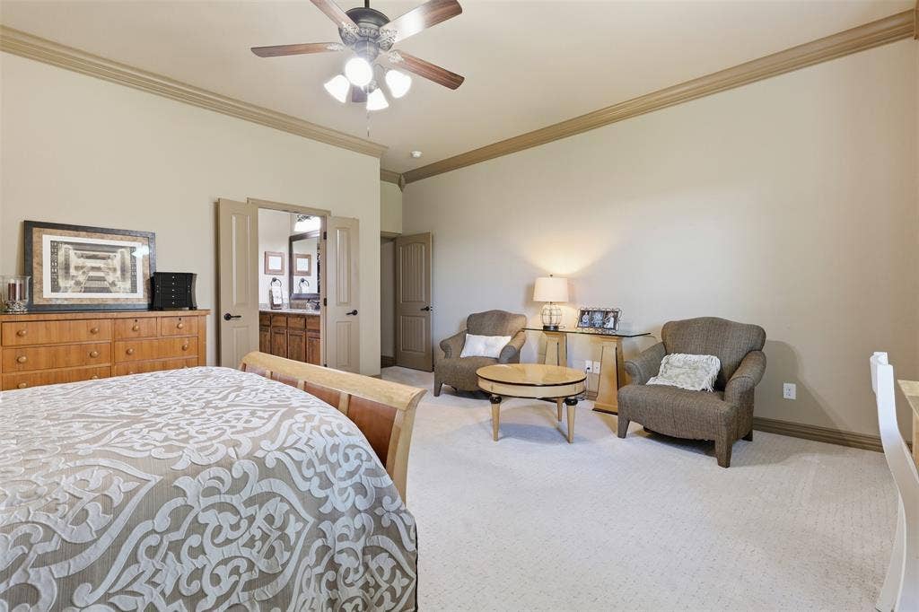 Spacious room featuring neutral carpeting and crown molding