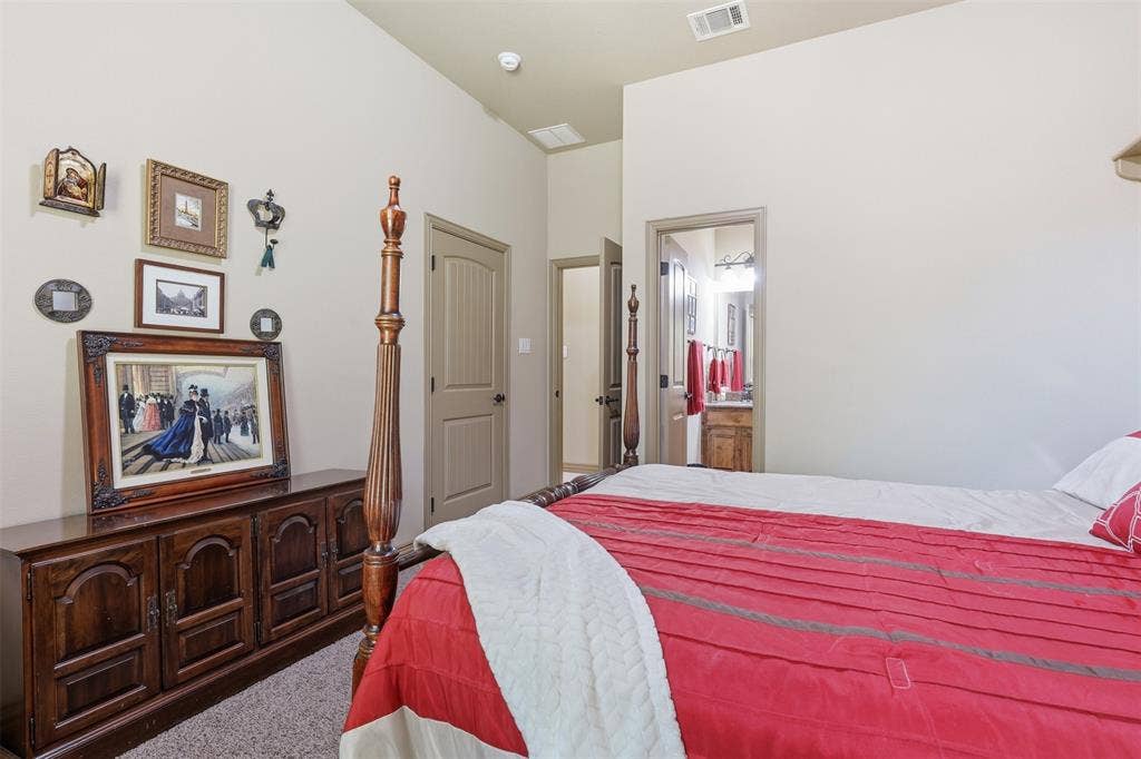 Spacious room featuring vaulted ceilings, neutral wall tones, and carpet flooring