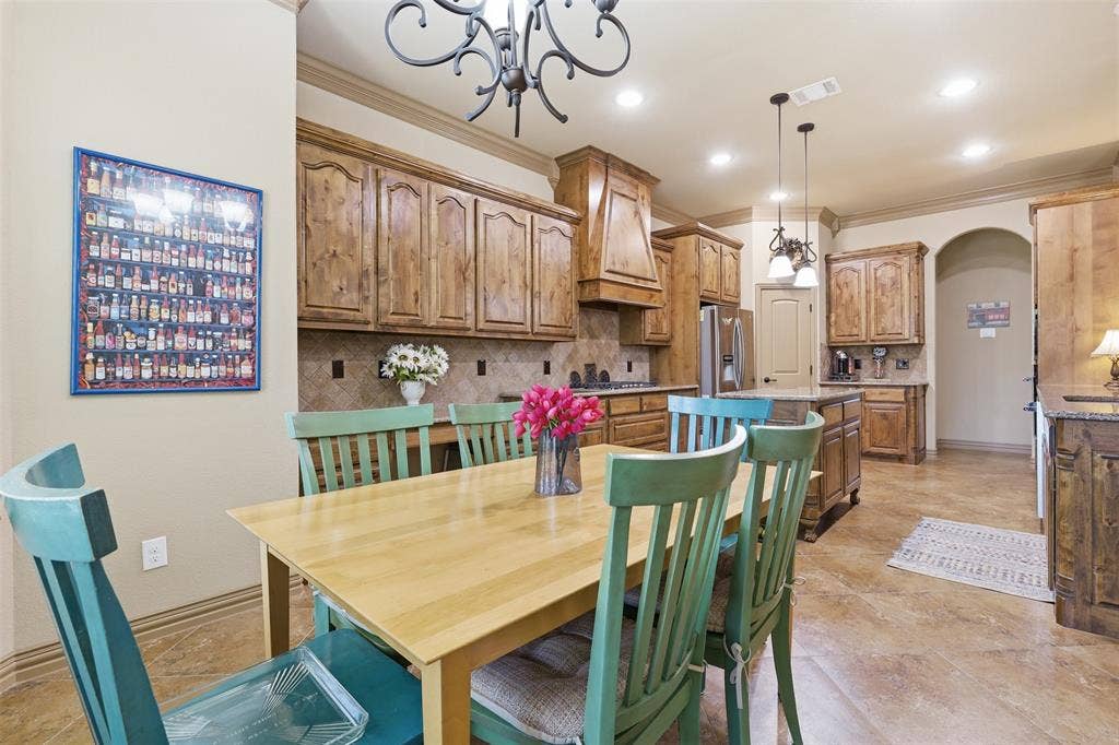 Spacious kitchen featuring extensive wood cabinetry, a tiled backsplash, and recessed lighting