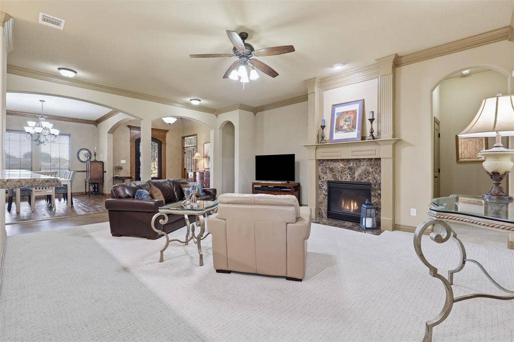 Living area featuring a fireplace with a stone surround and a substantial mantel