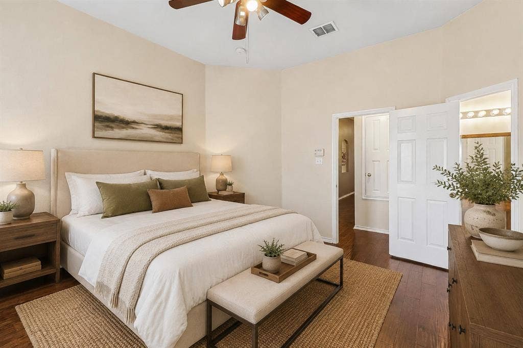 Bedroom featuring wood-finish flooring, light-toned walls, and a ceiling fan