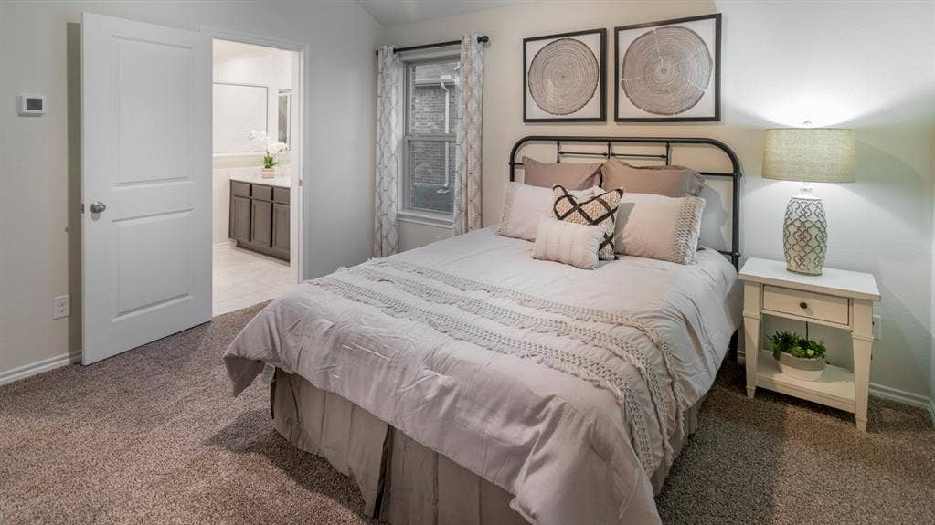 5618 Gannet Place, Crandall, TX 75114 Carpeted bedroom featuring a window with patterned drapes, a white paneled door, and a thermostat