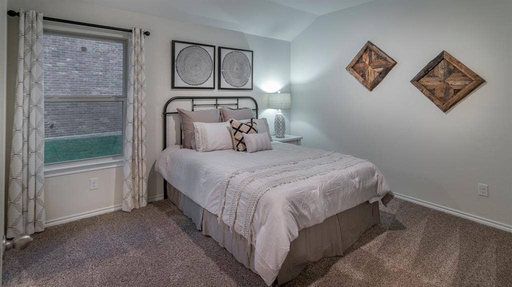 5618 Gannet Place, Crandall, TX 75114 Carpeted bedroom featuring a double-hung window, crown molding, and a sloped ceiling