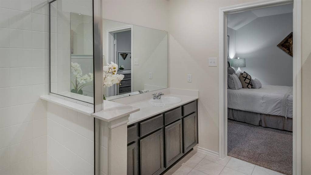 5618 Gannet Place, Crandall, TX 75114 Bathroom vanity with a white countertop and undermount sink, complemented by gray cabinetry
