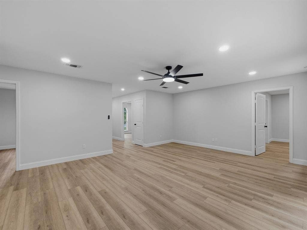 105 E Foggle Street, Athens, TX 75751 Primary living area looking toward primary entrance and kitchen area