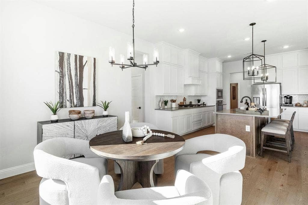 Table and kitchen of Kentsdale Farms home in DeSoto, TX by Kindred Homes