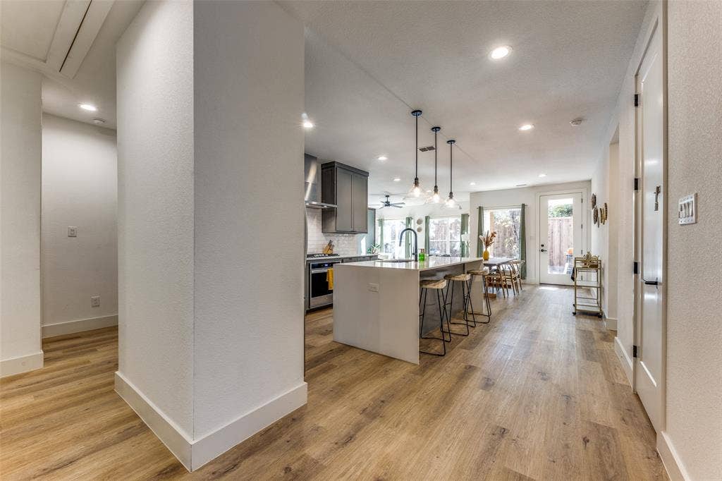 1116 Muncie Avenue, Dallas, TX 75212 Open concept living area featuring wood-finish flooring, recessed lighting, and a contemporary kitchen