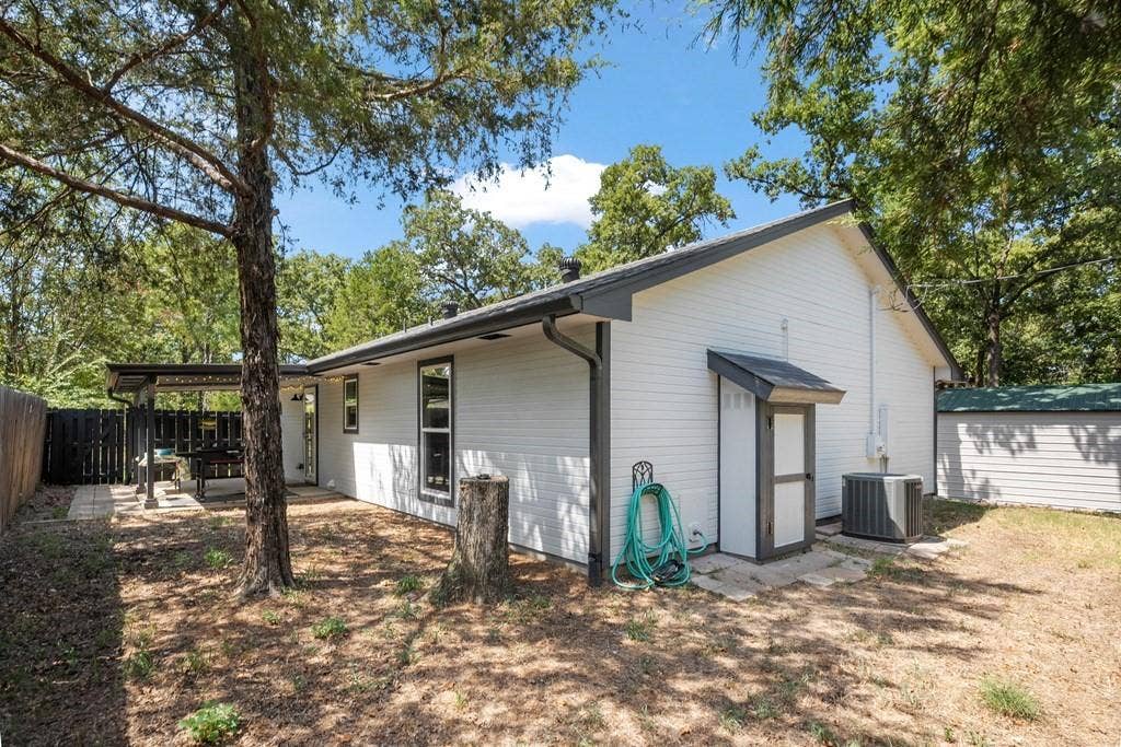 138 Wildgrove Drive, Gun Barrel City, TX 75156 Rear view of house, back porch & propane tank close