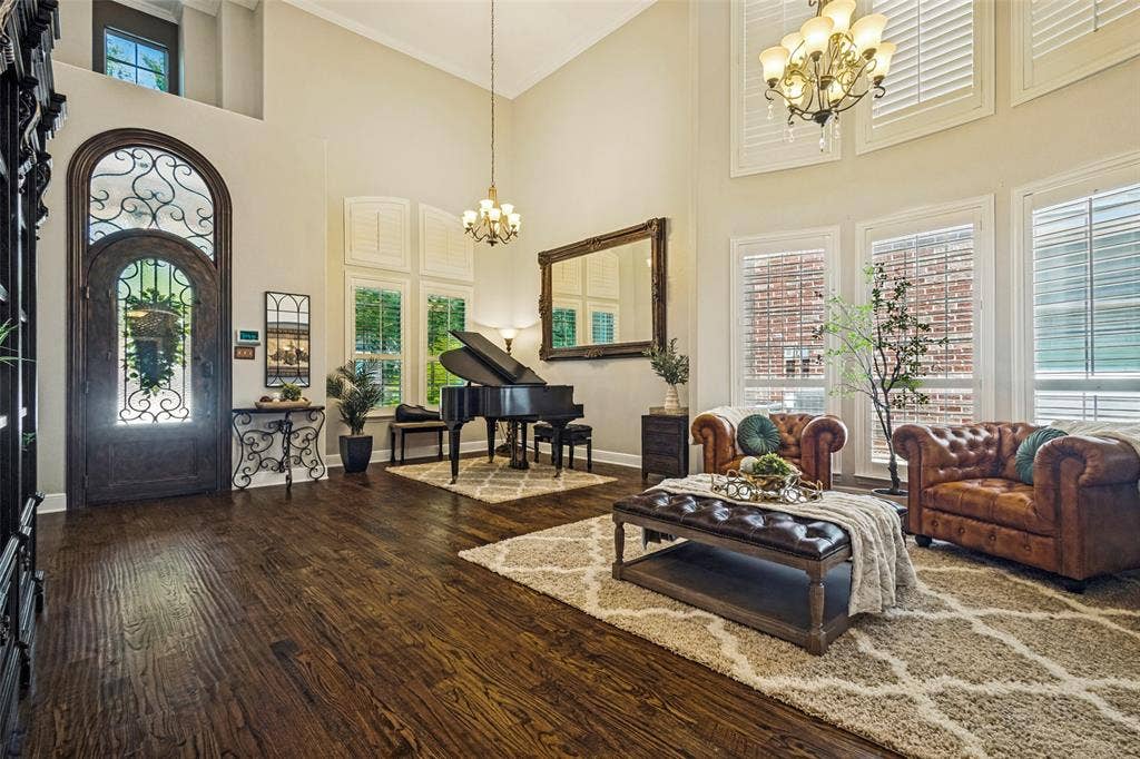 Formal living and dining areas being used as piano room and sitting area. House features imported handmade and unique front door.
