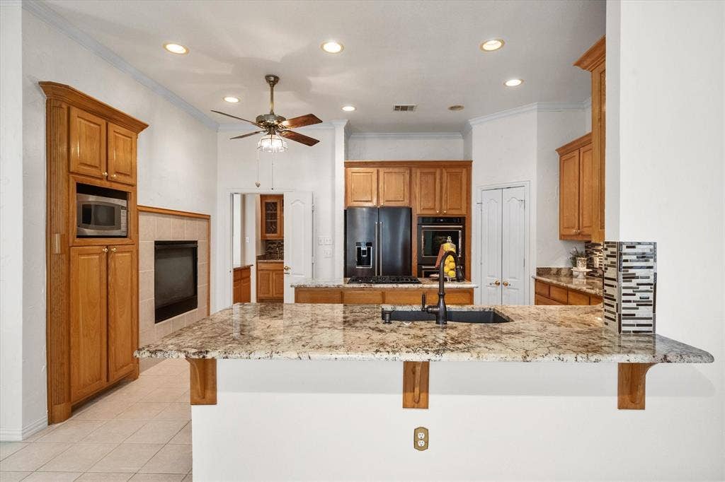 1013 Brook Arbor Drive, Mansfield, TX 76063 Kitchen has granite, stainless applianes, plenty of cabinet and counter space