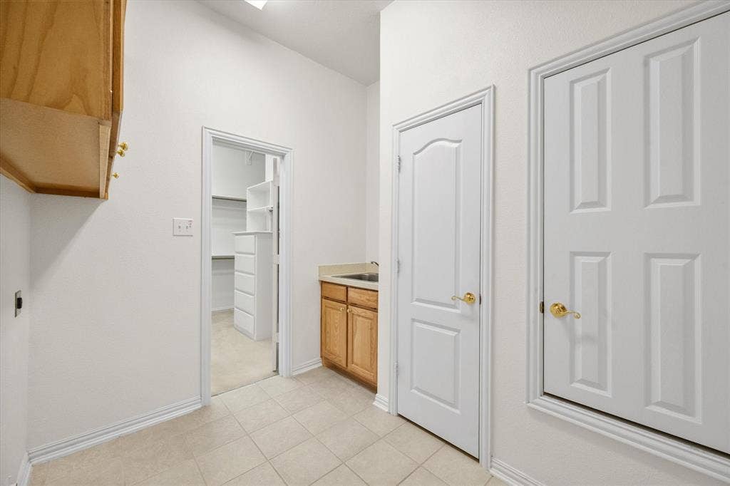 1013 Brook Arbor Drive, Mansfield, TX 76063 Large laundry room with closet, cabinets and sink