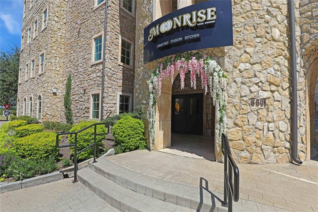 6601 Mediterranean Drive, #6101, McKinney, TX 75072 Stone veneer exterior featuring multiple windows with trim
