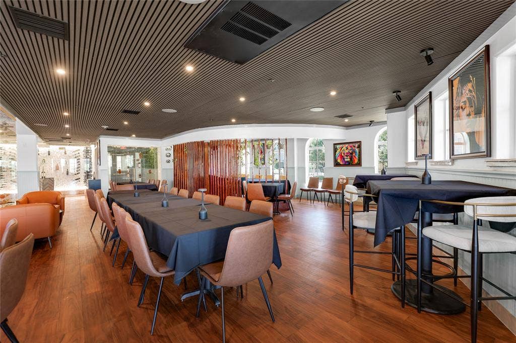 6601 Mediterranean Drive, #6101, McKinney, TX 75072 Spacious dining area featuring wood-finish flooring, a slatted ceiling, recessed lighting, and arched windows