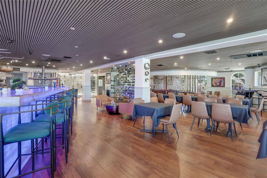 6601 Mediterranean Drive, #6101, McKinney, TX 75072 Open-plan commercial interior featuring wood-finish flooring and a slatted ceiling