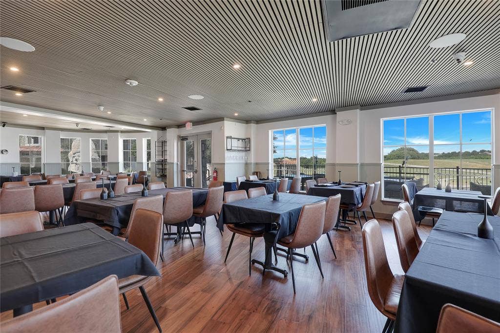 6601 Mediterranean Drive, #6101, McKinney, TX 75072 Spacious dining area featuring wood-finish flooring, a slatted ceiling, and expansive windows