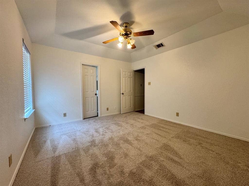 2812 Howard Court, Denton, TX 76209 Spacious room featuring neutral carpeting and a tray ceiling