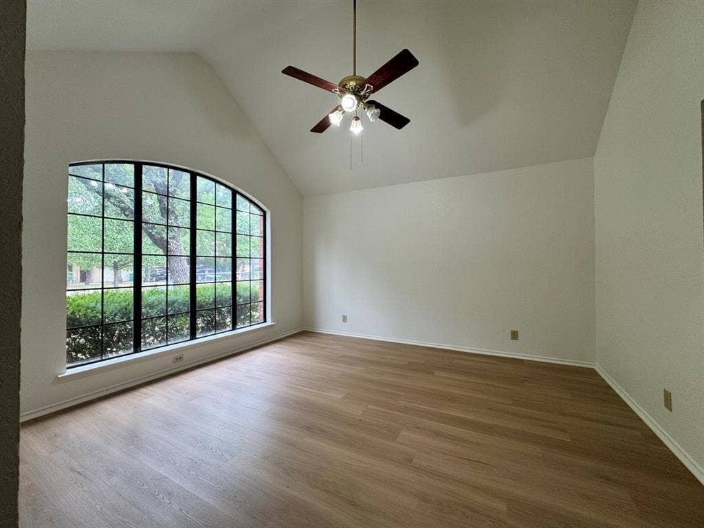 2812 Howard Court, Denton, TX 76209 Room featuring a vaulted ceiling and a large arched window with grid-patterned panes