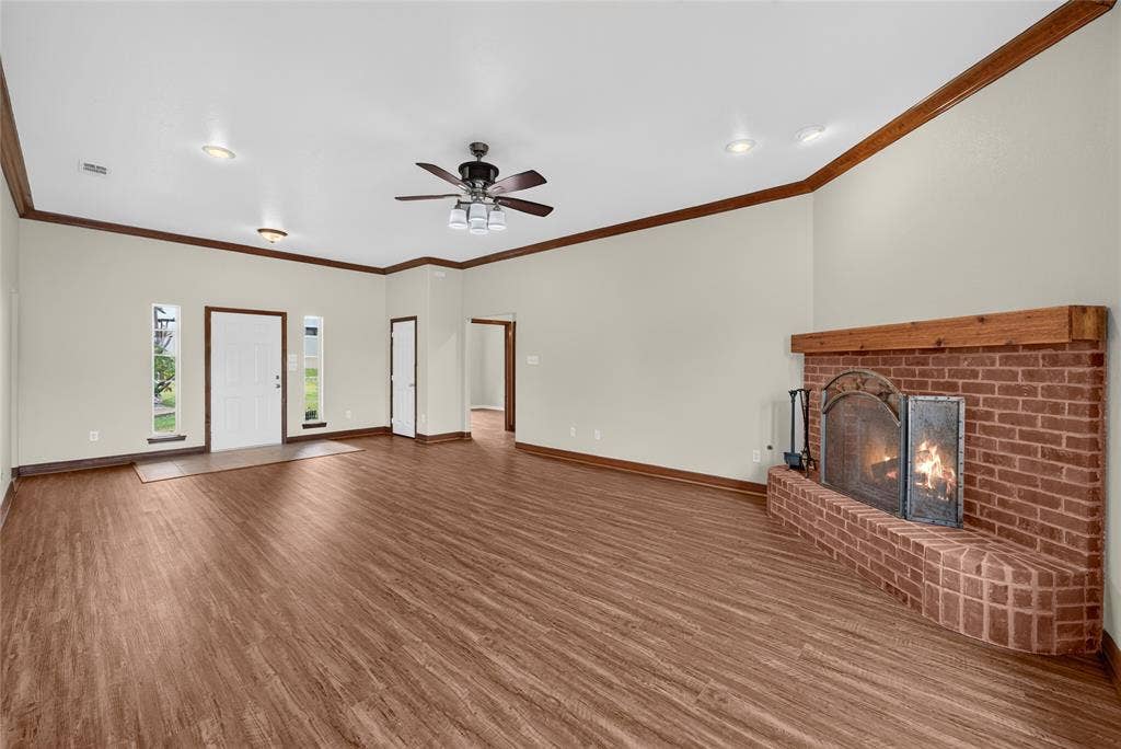 18723 Sims Lane, Nevada, TX 75173 Spacious living area featuring a brick fireplace with a wood mantel