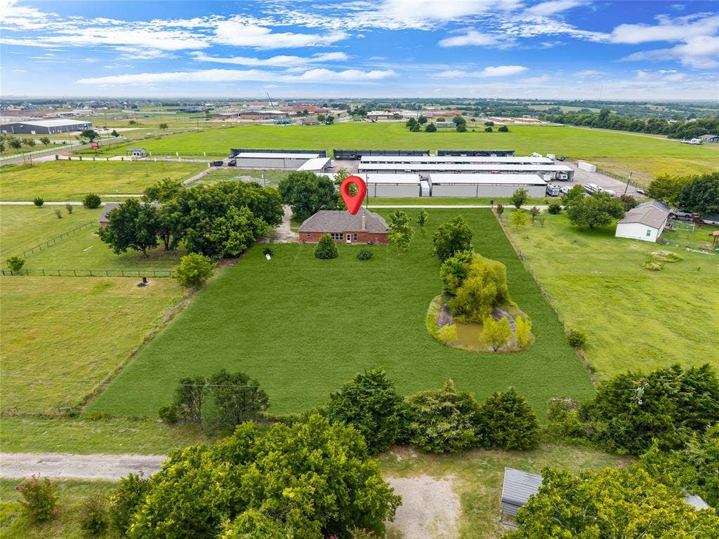 18723 Sims Lane, Nevada, TX 75173 Expansive green property featuring a brick residence, mature trees, and a pond